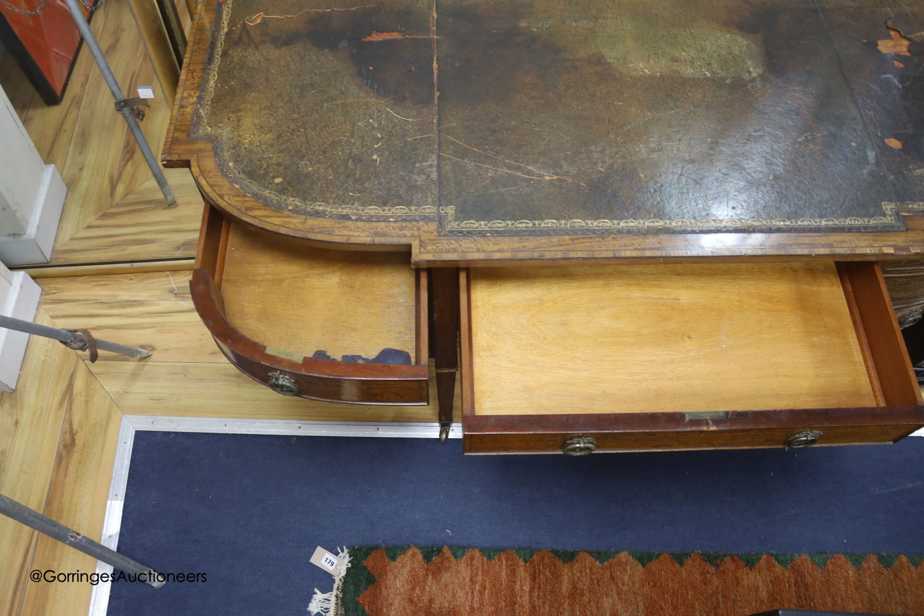 An Edwardian banded breakfront kneehole desk, length 142cm, depth 63cm, height 75cm
